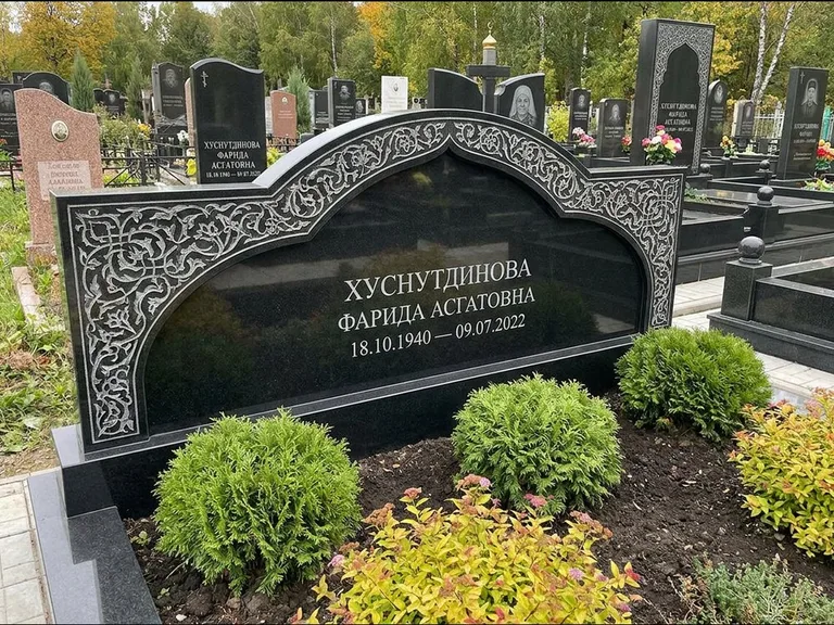 Мусульманский памятник: вытянутая горизонтальная семейная стела с аркой — белая гравировка силуэта мечети с минаретами, участок с декоративными кустами, работа «Зарипова» в Пензе